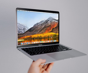 Person Holding MacBook Air Mockup PSD Template - Screen Display