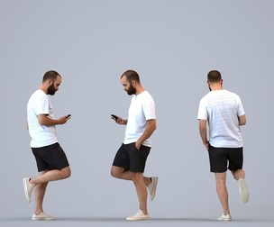 00350_Mansur004 Adult Middle Eastern man standing in public space with smartphone
