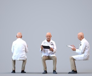 00396_James009 Senior Caucasian man reading in medical setting wearing transitional seasonal
