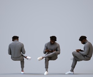 00477_Aaron010 Adult Black male sitting at home with smartphone in transitional seasonal clothing